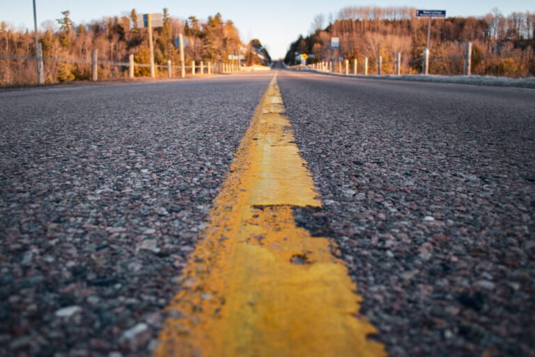 A gold center line on an open road stretching toward the horizon